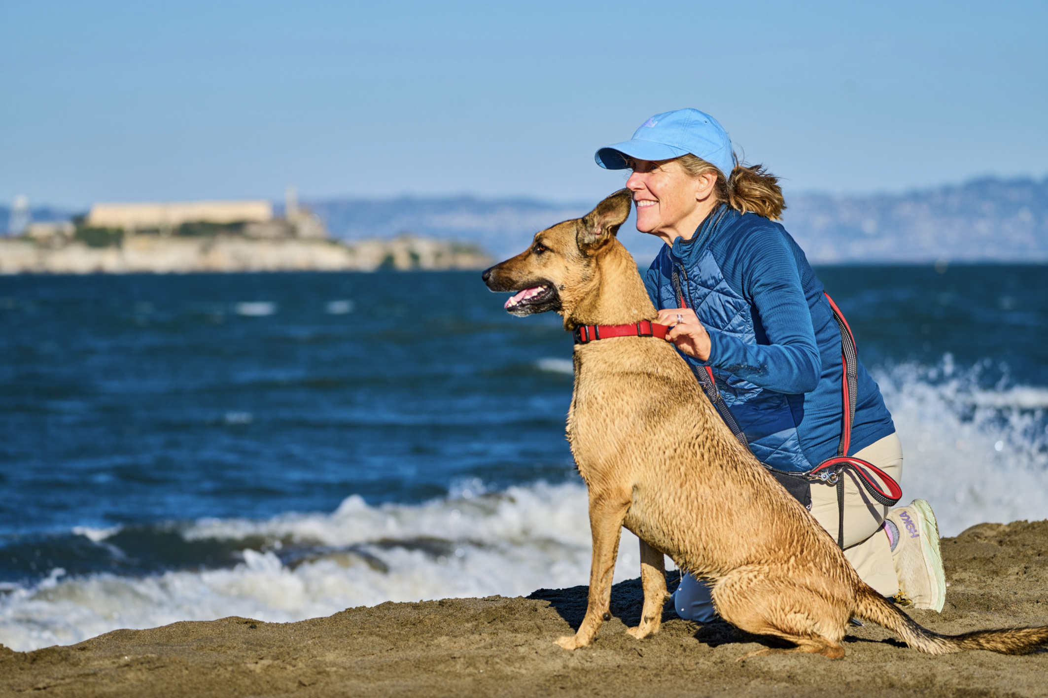 Dog and owner on sandy beach with heavy-duty Leashrr 2.0 leash during Memorial Day activities